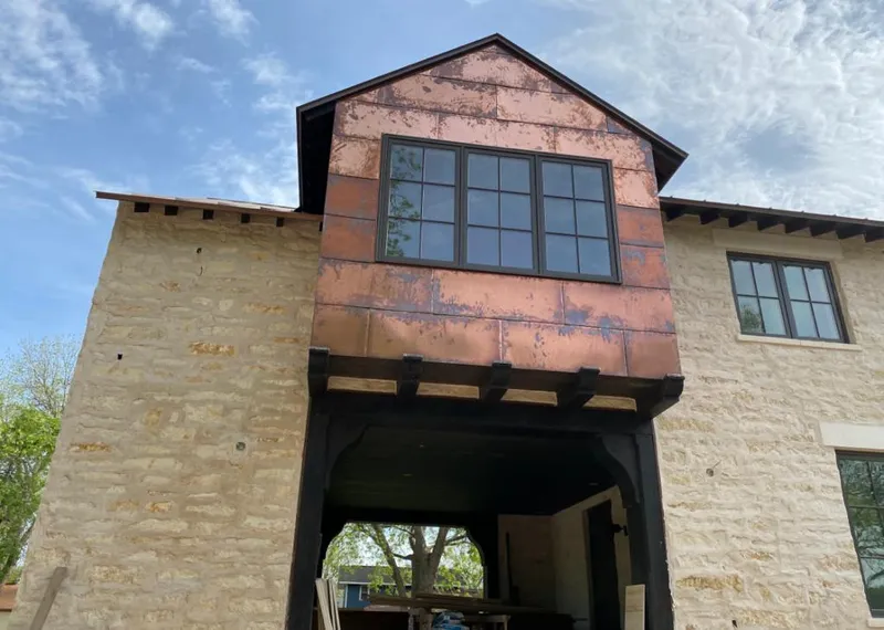 Copper metal panel facade on a stone building for Metal Roof Coating in Kimberly